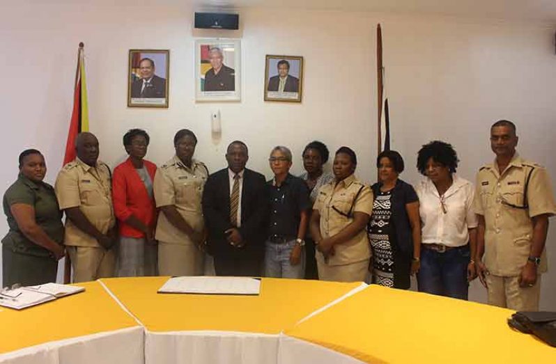Crime Chief Paul Williams, centre, is flanked by Red Thread representatives and senior police officers.