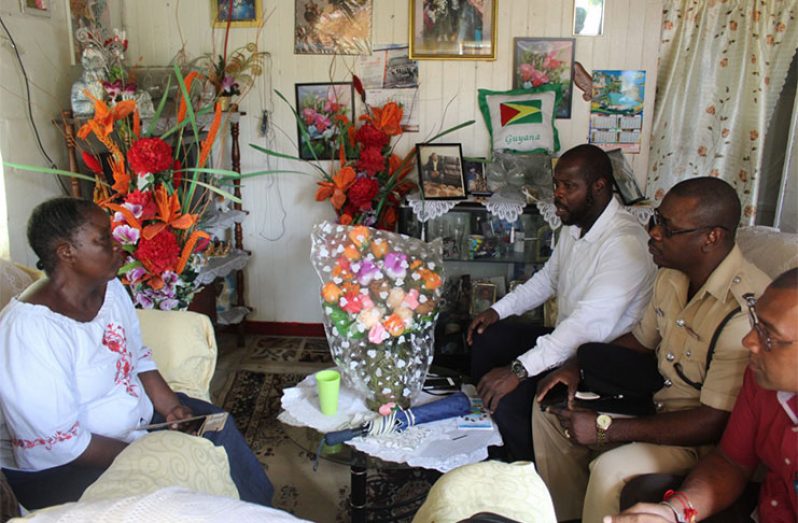 Senior police officers in conversation with the bereaved Loraine Peters