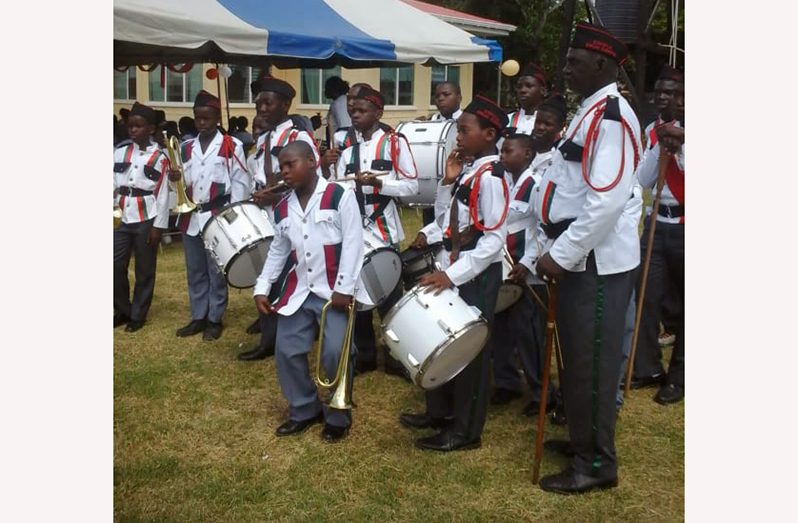 ‘Uncle Polo’ and his young musicians preparing to perform at an event in New Amsterdam