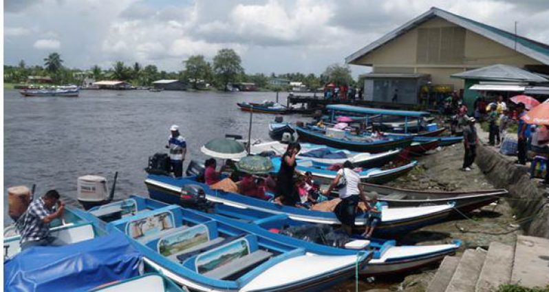 Private speed boats in the Pomeroon River at Charity waiting on passengers