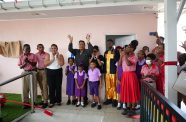 Terry Mohammed (centre) and Minister of Education, Priya Manickchand (left) with children and others at the commissioning of the Edward Mohammed Swimming Pool