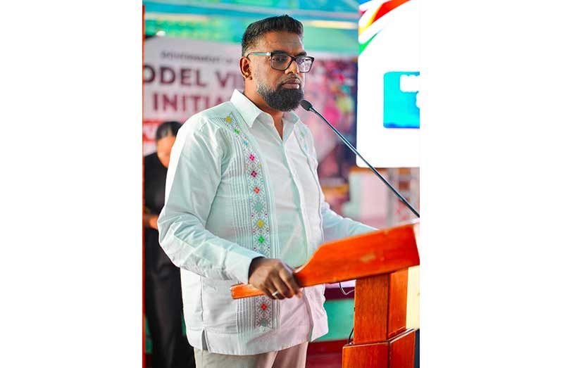 President Dr Mohamed Irfaan Ali engages residents on the proposal for a poultry hub during the community consultation held at Good Hope on Monday, pointing to the large number of residents already engaged in poultry production on a small scale