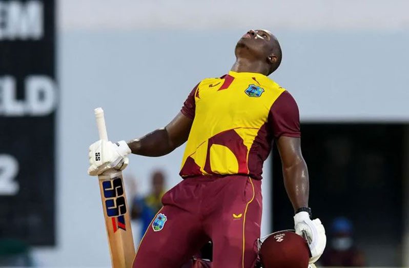 Rovman Powell sinks to his knees after reaching three figures  Randy Brooks/AFP via Getty Images