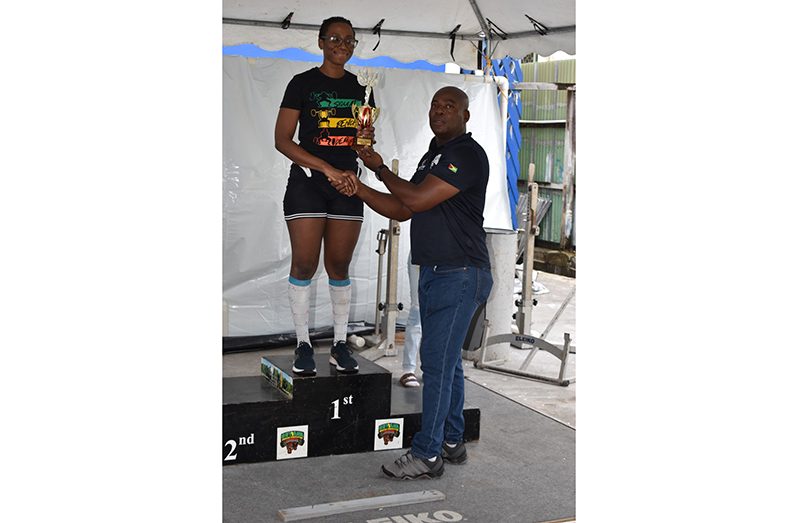 Kezia Joseph receive her accolade from GAPLF head, Franklin Wilson