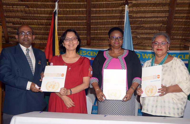 From left, Indian High Commissioner to Guyana, Venkatachalam Mahalingam; UN Resident Coordinator, Mikiko Tanaka; Minister of Public Health, Volda Lawrence; and Director of the UNFPA’s Sub-Regional Office for the Caribbean, Alison Drayton with the project agreement (Adrian Narine photo)