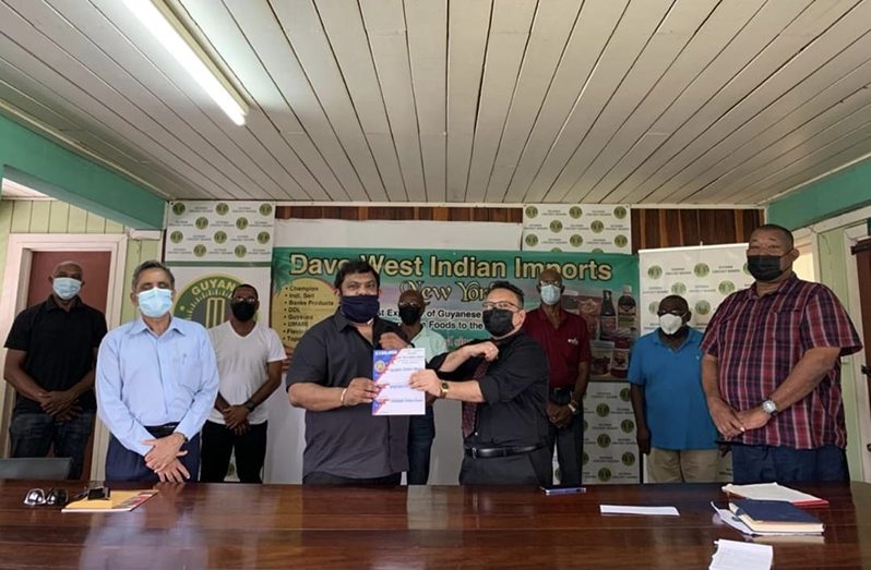 GCB president Bissoondyal Singh (right) and Dave Narine (left) are surrounded by other GCB executives following the launch of the Trust Fund yesterday.