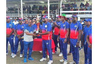 President Ali collects the winning trophy from Commissioner of Police Clifton Hicken