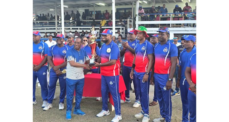 President Ali collects the winning trophy from Commissioner of Police Clifton Hicken