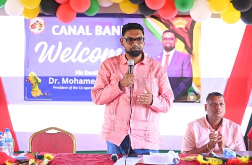 President Dr. Irfaan Ali addresses residents of Canal Bank in Region One. Also pictured is Housing Minister Collin Croal (OP photo)