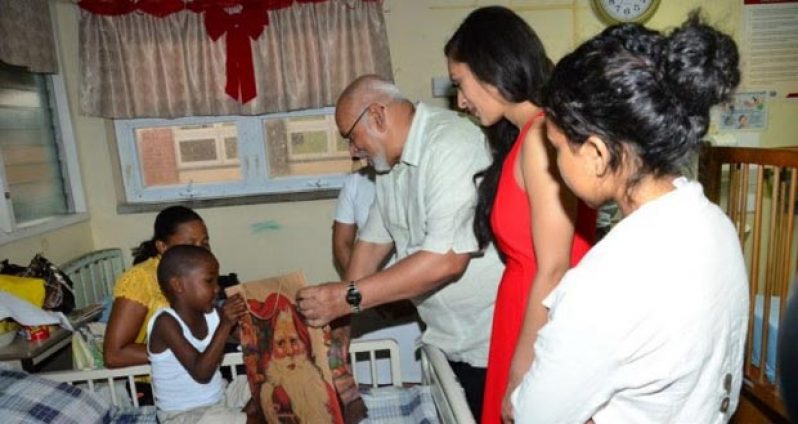 President Donald Ramotar handing over a present to a patient at the Pediatric Ward of the GPHC