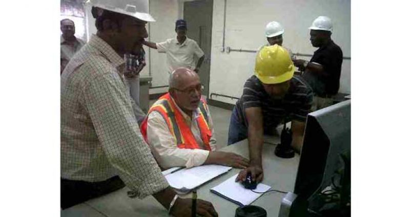 President Donald Ramotar at the Skeldon factory recently in the control area. The President being shown how the factory operates by staff of the estate (GINA photo)