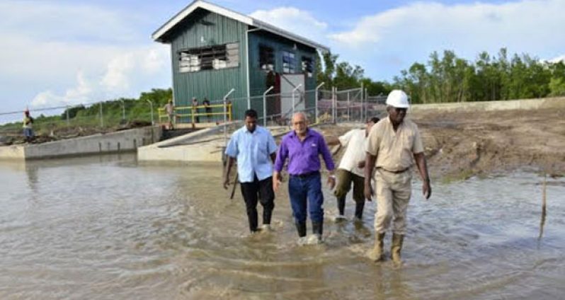 President Donald Ramotar, and Public Works Minister, Robeson Benn head towards another East Coast village after checking out the pump station at Paradise