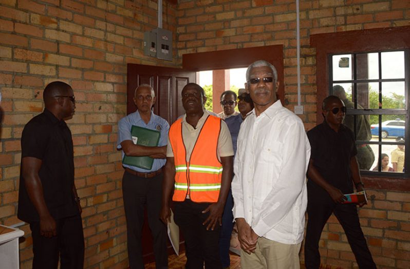 President David Granger (second from right) inspecting one of the low-income homes built in Prospect Housing Scheme using the clay bricks from the hinterland (Adrian Narine photo)