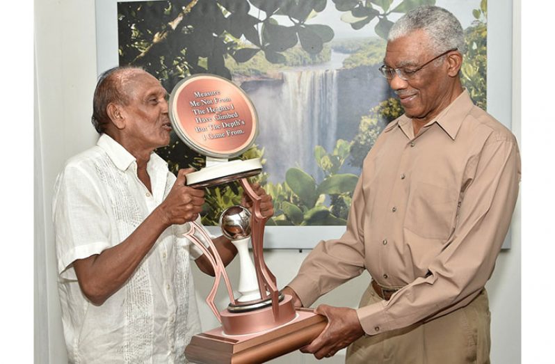 President David Granger receives this abstract work of art from Mr. Bobby Hussein