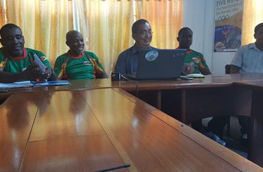 Rugby team manager Robbie Roberts sits with coach Lawrence Adonis, GRFU president Peter Green and senior player Avery Corbin. (Stephan Sookram photo)