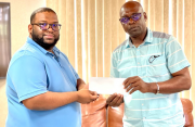 Clifton Singh presented the monetary donation to Aubrey ‘Shanghai’ Major