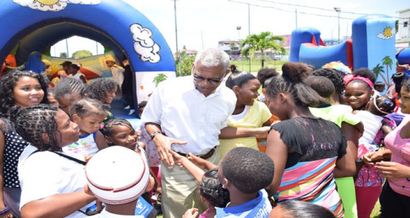 President David Granger interacts with children at the Fun Day hosted by the CIOG, yesterday (Kawise Wishart/GINA photo)
