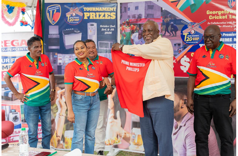 Prime Minister Mark Phillips, second from right, with his tournament shirt. Others in picture, from left, are Inderjeet Persaud, GSCL Secretary Telesha Ousman, Vice-president John Ramsingh and President Ian John