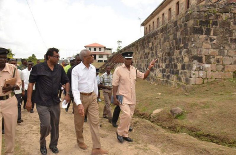 President David Granger and Public Security Minister Khemraj Ramjattan and prison officials during their tour of the Mazaruni Penal Settlement last year (File Photo)