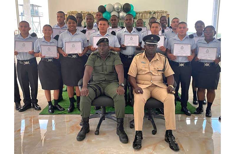 Acting Deputy Director of Prisons Kevin Pilgrim (seated left) with Officer-in-Charge of Mazaruni Prison Carlton Cameron flanked by the new prison warders