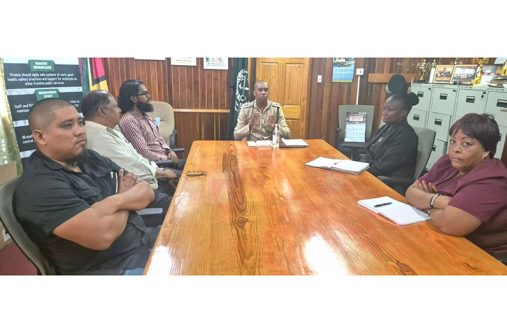 Director of Prisons Nicklon Elliott (centre) with medical officials of the GPS