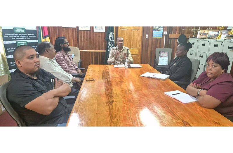 Director of Prisons Nicklon Elliott (centre) with medical officials of the GPS