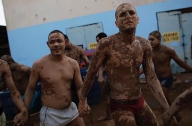 Prisoners (left to right) Raimundo Souza, 24, Jairo Caracara, 38 and Tiago Kinkas, 23, are covered in clay in a therapy session