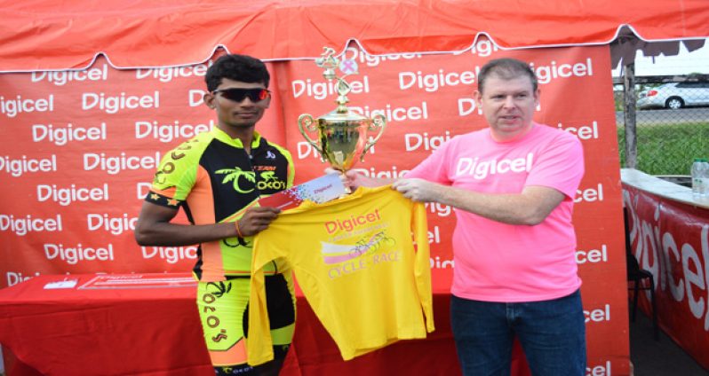 Raynauth `Obeahman’ Jeffrey” left accepts the winners yellow jersey along with his cheque and trophy from Digicel’s CEO Kevin Kelly for winning the 4th annual sponsored Cancer Awareness Two-Stage cycle road race yesterday (Photo by Samuel Maughn).