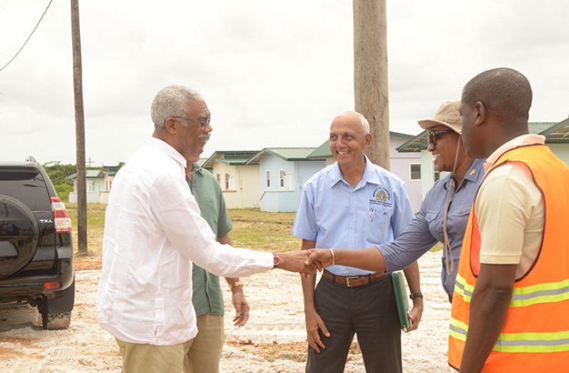 President David Granger (left) greets Minister with responsibility for Housing, Annette Ferguson as he arrived at Prospect New Housing Scheme on Friday. Looking on are Minister of Communities, Ronald Bulkan (centre) and CH&PA CEO Lelon Saul (right).