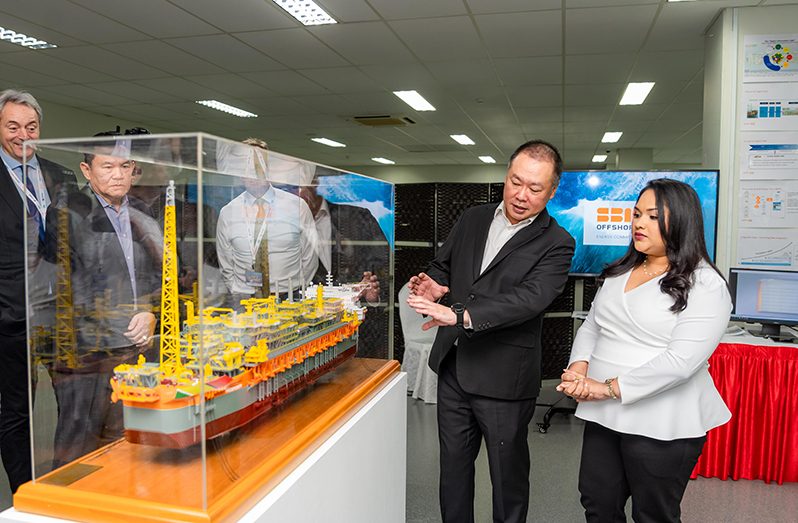 Mr Chris Ong, CEO of Keppel Offshore & Marine, shows First Lady Arya Ali a replica of the Prosperity and explains how the vessel will operate to produce 220,000 barrels of oil per day in Guyana