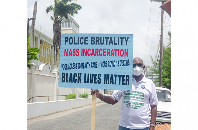 Attorney-at-law Mayo Robertson in protest outside the US Embassy here on Tuesday in solidarity with demonstrators the world over over the wanton killing of yet another African-American on the streets of the USA
