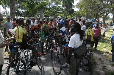 President of RBC Brian Allen (foreground) tries his valiant best to start the Category 1 to 3 feature event, even as the cyclists and cycling enthusiasts prevent same from occurring by converging on the track.