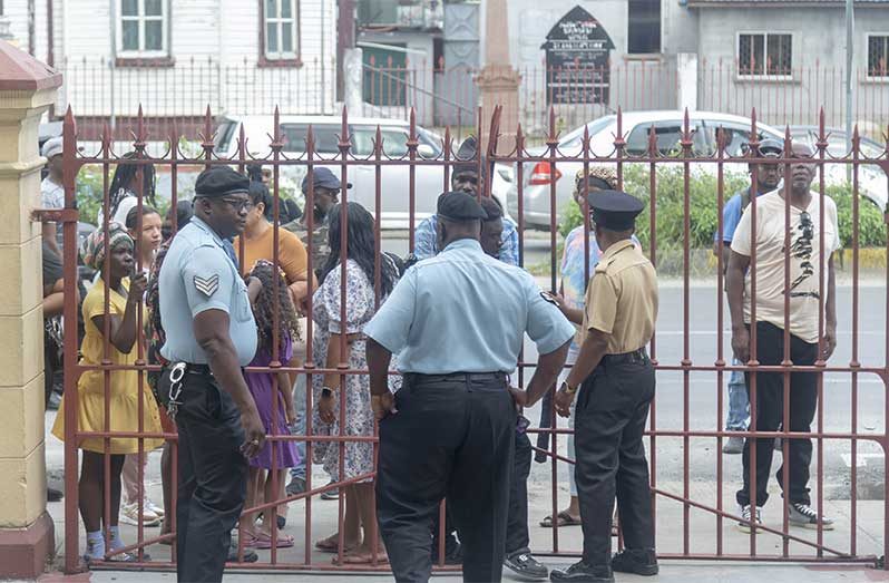 Family members of the accused protest outside the courthouse, calling for justice and alleging police brutality during the recent arrests linked to the Georgetown unrest (Japhet Savory photo)