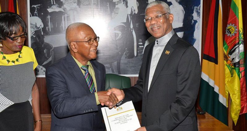 President David Granger (right) receiving the Report of the Commission of Inquiry into the Public Service from Chairman Professor Harold Lutchman (centre). At left is Commissioner Sandra Jones