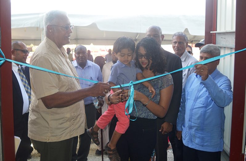Minister of Agriculture, Noel Holder (left) and Junior Minister of Finance, Jaipaul Sharma (right) cut the ribbon to declare the pump station open (MoA photo)