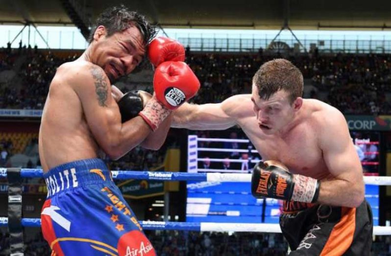 Jeff Horn of Australia punches Manny Pacquiao of the Philippines. AAP/Dave Hunt/via REUTERS