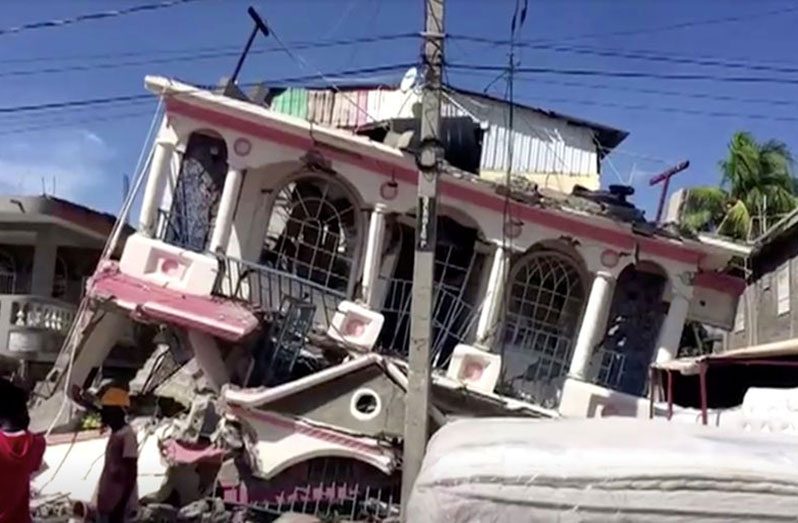 A view of a collapsed building following an earthquake, in Les Cayes, Haiti, in this still image taken from a video obtained by Reuters on August 14, 2021
