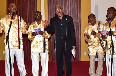 David Granger joined the Victoria Regia Quartet in singing “Let Us Cooperate” at the launch of their collection of national songs called New Day. (Adrian Narine photo)