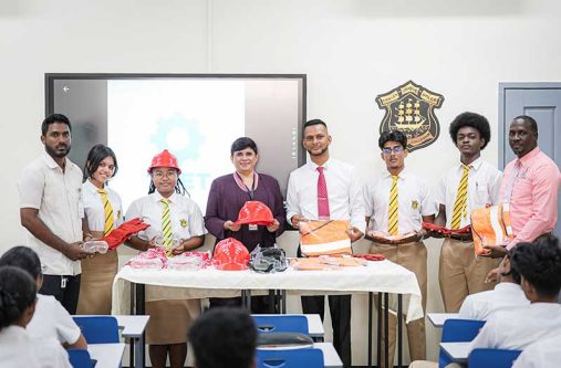 Fourth from left: Headmistress/ Principal Queen's College, Mrs. Rajkumarie Lall and Deputy Chief Education Officer (Technical), Dr. Ritesh Tularam, flanked by students and other officials at the formal handing over of the PPE at the newly established TVET Block at Queen’s College