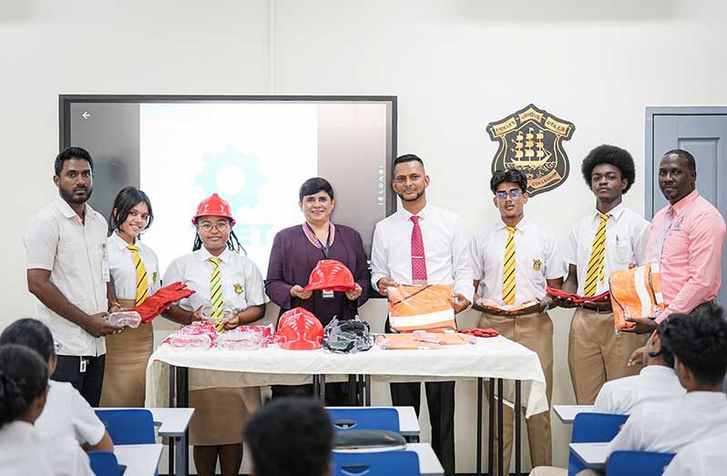 Fourth from left: Headmistress/ Principal Queen's College, Mrs. Rajkumarie Lall and Deputy Chief Education Officer (Technical), Dr. Ritesh Tularam, flanked by students and other officials at the formal handing over of the PPE at the newly established TVET Block at Queen’s College