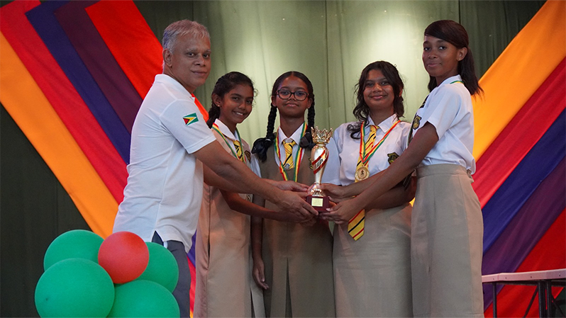 Queen's College Girls Team Receiving the 1st Place Prize from GCF President Anand Raghunauth