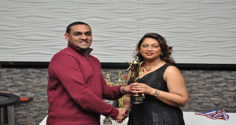 Ravendra Madholall receives one of his awards from club official Jenny Tajpaul.