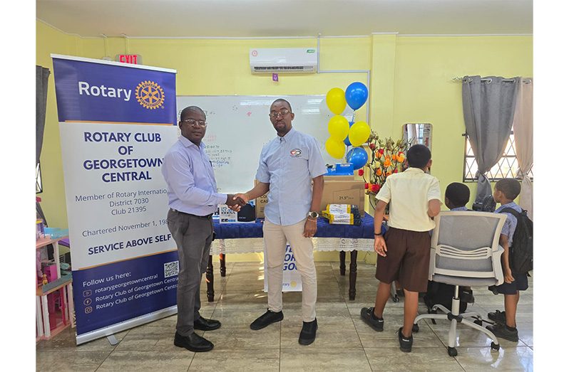 RCGC President, Lloyd David, with Manager of Children and Family Centre, Qrette Francois with the donated computers and accessories on the table