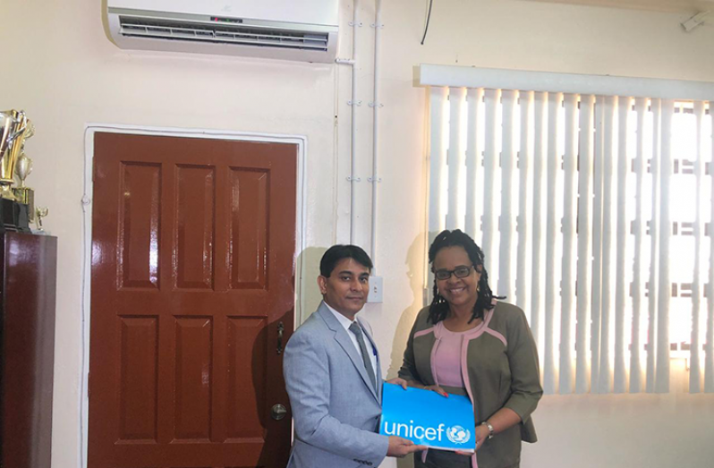 Region Four Regional Executive Officer (REO), Pauline Lucas and UNICEF Deputy Country Representative for Guyana and Suriname, Irfan Akhtar, holding the signed MoU