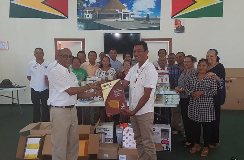 FCPF-REDD+ Project Coordinator Clayton Hall hands over office supplies to NTC Chairman Nicholas Fredericks and others