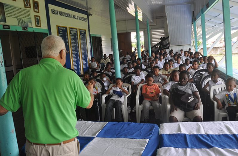 Joseph ‘Reds’ Perreira talks to students yesterday, at the Malteenoes Cricket Academy.