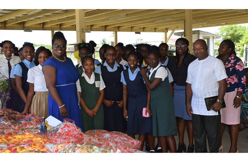 [At right] Patrick Chinedu Onwuzirike with senior education officials of the Department in Region 5 with some female graduates