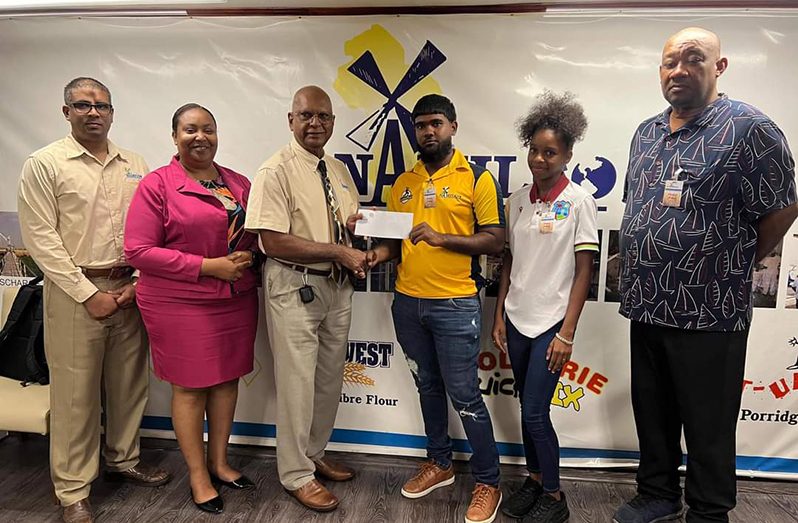 NAMILCO Managing Director Sukai hands over sponsorship cheque to RHTYSC Matthew Pottaya in the presence of other officials