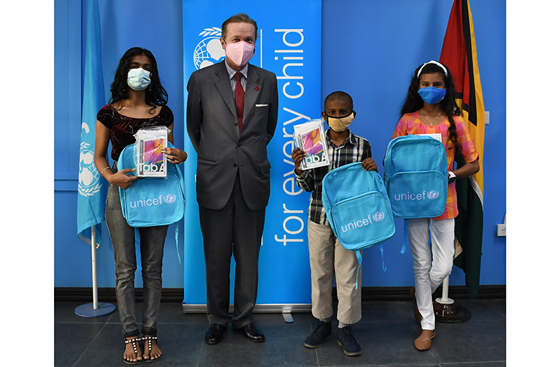 UNICEF Representative, Nicolas Pron, with three of the winners of UNICEF’s Guyana’s Reimagine Illustration Challenge, from left to right, Tiffani, Sajid, and Elliana, who were presented with tablet computers on Friday, 29 January 2021
