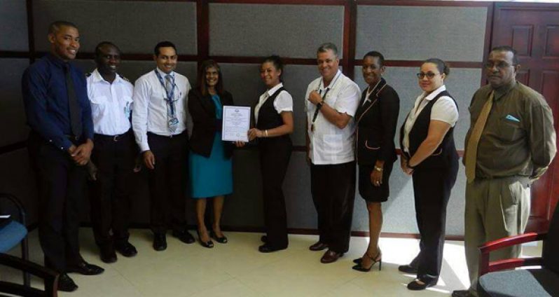 Director-General of GCAA, Chaitrani Heeralall, hands over the Approved Maintenance Organisation certificate to Captain Mrs. Debbie Gouveia in the presence of officials of the GCAA and Roraima Airways.